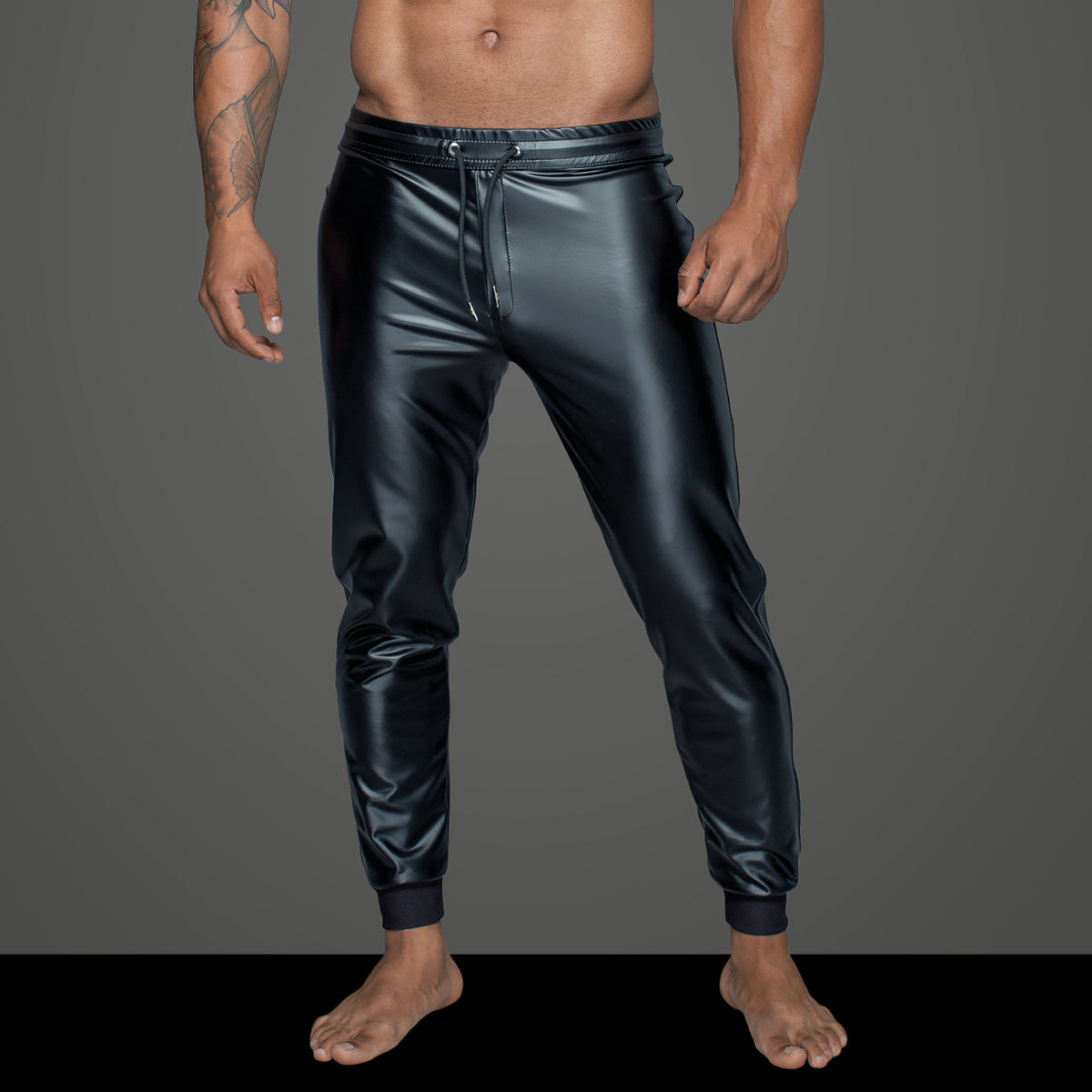 Men’s black wetlook treggings, waistband and front zipper detail.