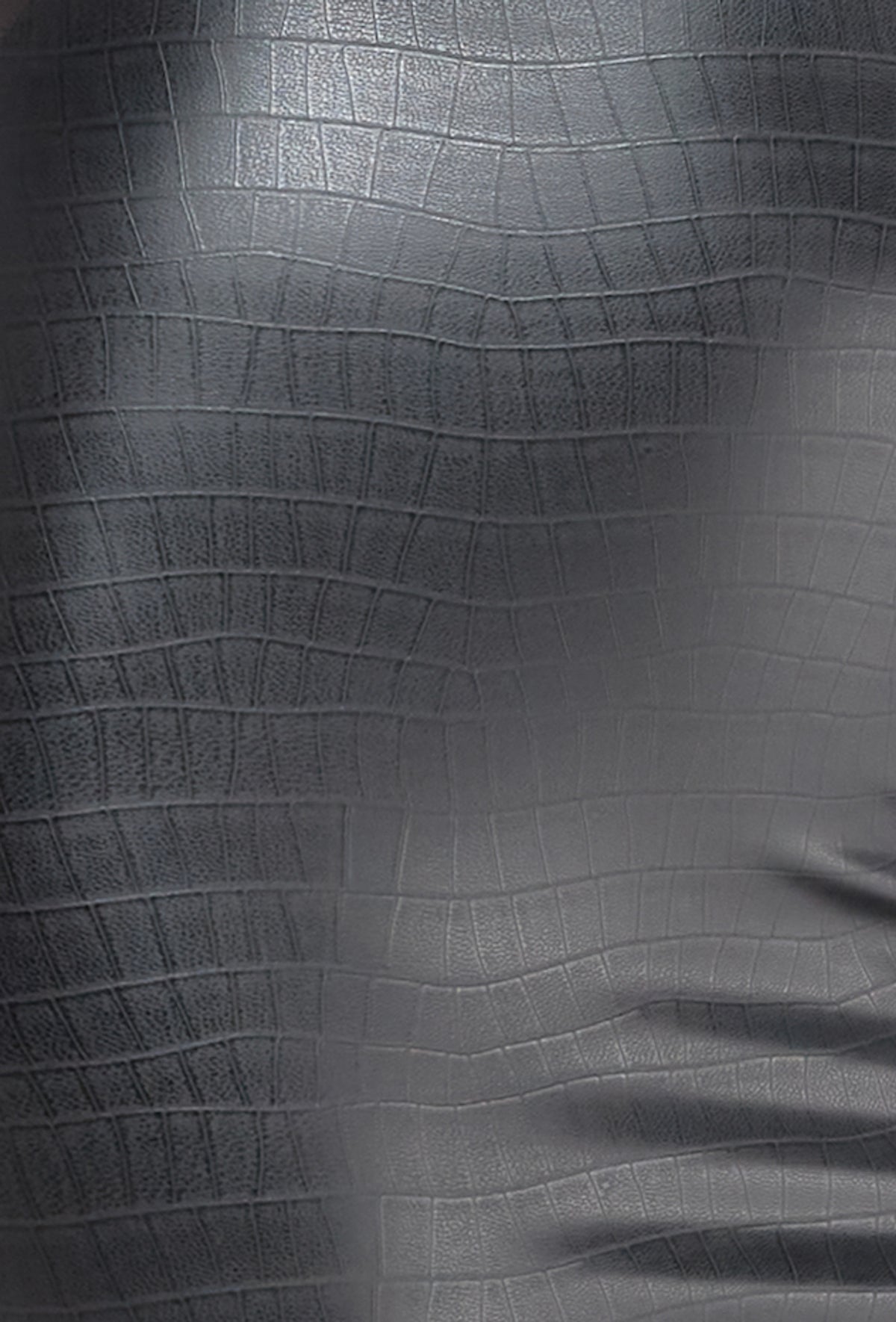 Close-up of black crocodile-pattern wetlook fabric.