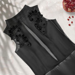 Black sheer tulle dress bodice with floral embroidery, flat detail.