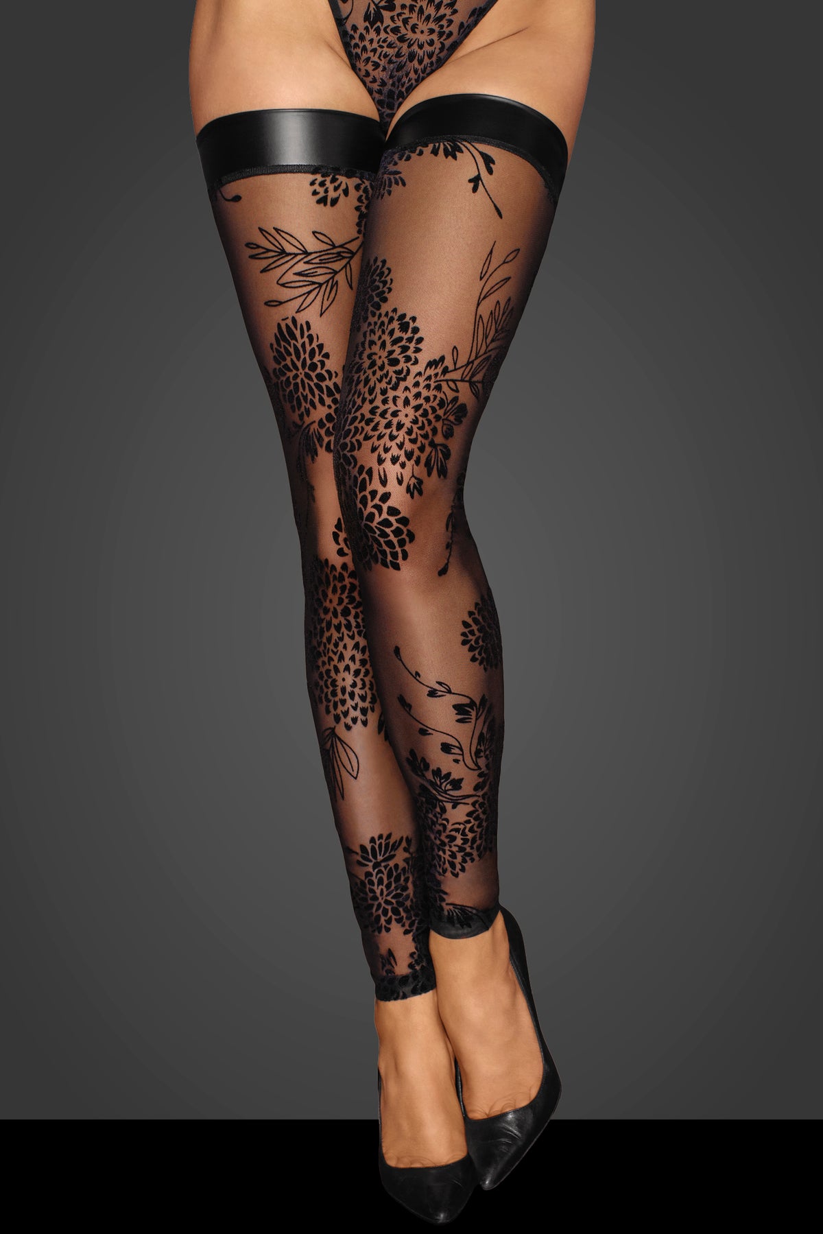 Black floral flock tulle stockings with wetlook top bands, front view.
